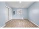 Charming bedroom with light blue walls, wood flooring, and a large closet at 11320 Stoeppelwerth Dr, Indianapolis, IN 46229