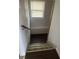 Basement stairs with dark wood-look flooring and a railing at 1510 Spruce St, Indianapolis, IN 46203