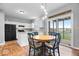 Kitchen with island, white cabinets, and breakfast nook at 15960 Arbor Grove Blvd, Noblesville, IN 46060