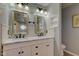 Double vanity bathroom with marble countertop and stylish light fixtures at 2612 Kirk Ct, Lebanon, IN 46052