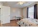 Bedroom with a dark wood bed frame, hardwood floors, and access to another room at 2612 Kirk Ct, Lebanon, IN 46052