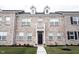 Brick townhouse exterior with a walkway, landscaping, and a black front door at 2894 Maricopa Blvd, Whitestown, IN 46075