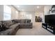 Living room with sectional sofa, TV, and view of kitchen at 2894 Maricopa Blvd, Whitestown, IN 46075