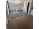 Bright dining room featuring a chandelier and hardwood floors at 307 S Mulberry S St, Waldron, IN 46182