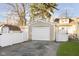 Single car detached garage with white door and adjacent yard at 310 Berkley Rd, Indianapolis, IN 46208