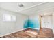 Bright bedroom featuring wood-look floors and a painted accent wall at 33 Miami Dr, Noblesville, IN 46062