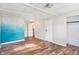 Spacious bedroom with wood-look floors and painted accent wall at 33 Miami Dr, Noblesville, IN 46062