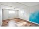 Bright bedroom with wood floors and blue accent wall at 33 Miami Dr, Noblesville, IN 46062