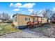 Yellow mobile home with green trim and a wooden porch at 33 Miami Dr, Noblesville, IN 46062