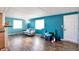 Living room with teal walls and wood flooring at 33 Miami Dr, Noblesville, IN 46062