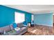 Living room with teal walls, wood floors, and a couch at 33 Miami Dr, Noblesville, IN 46062