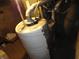 Unfinished basement with exposed pipes and water heater at 443 N Centennial St, Indianapolis, IN 46222