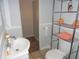 Simple bathroom with white toilet and sink, and additional storage at 443 N Centennial St, Indianapolis, IN 46222