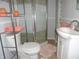 Clean bathroom with white vanity, shower, and updated shelving at 443 N Centennial St, Indianapolis, IN 46222