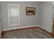Bedroom with hardwood floors, neutral walls, and a large window at 443 N Centennial St, Indianapolis, IN 46222