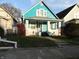 Cute teal bungalow with white trim, porch, and small yard at 443 N Centennial St, Indianapolis, IN 46222