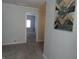Bright hallway with neutral walls and carpet leading to other rooms at 443 N Centennial St, Indianapolis, IN 46222