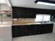 Kitchen with black cabinets and updated appliances at 443 N Centennial St, Indianapolis, IN 46222