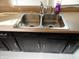 Double stainless steel sink with dark brown cabinets at 443 N Centennial St, Indianapolis, IN 46222