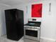 Kitchen features stainless steel range and black refrigerator at 443 N Centennial St, Indianapolis, IN 46222