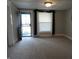 Spacious living room with carpeted floors and neutral walls at 443 N Centennial St, Indianapolis, IN 46222