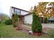 Two-story house with a brown door and attached garage. Lush green landscaping surrounds the property at 7144 Kimble Dr, Indianapolis, IN 46217