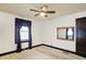 Bedroom with ceiling fan, navy curtains, and dark wood door at 722 S Sherman Dr, Indianapolis, IN 46203