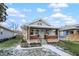 Cute bungalow with a brick facade, front porch and landscaping at 722 S Sherman Dr, Indianapolis, IN 46203