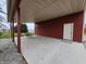 Covered patio area adjacent to garage with seating at 7820 W 800 N, Fairland, IN 46126