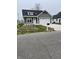 Gray sided house with white garage doors and landscaping at 850 E Nutter St, Martinsville, IN 46151