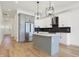 Modern kitchen with gray cabinetry, island, stainless steel appliances, and hardwood floors at 1018 Calvary St, Indianapolis, IN 46203