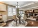 Bright dining area with glass table and four chairs, open to living room at 104 Elderberry Cir, Noblesville, IN 46062