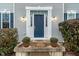 Inviting front entrance with blue door and potted plants at 10802 Midnight Dr, Indianapolis, IN 46239