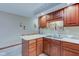 Cozy kitchen featuring wood cabinets and a corner sink at 114 Mackinac Ct, Indianapolis, IN 46227