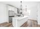 Stylish white kitchen with marble countertops, stainless steel appliances, and black fixtures at 1230 N Alabama St, Indianapolis, IN 46202