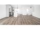 Open-concept kitchen and living area with wood flooring and white walls at 1230 N Alabama St, Indianapolis, IN 46202