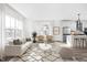 Bright, open living room with white walls, wood floors, and an adjacent kitchen at 1230 N Alabama St, Indianapolis, IN 46202