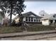 Charming bungalow with sunroom and steps leading to the front entrance at 1324 N Gale St, Indianapolis, IN 46201