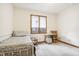 Bright bedroom with daybed, window, and small work desk at 142 E Banta Rd, Indianapolis, IN 46227