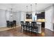 Kitchen with island seating, dark cabinetry, and hardwood floors at 1710 Rossmay Dr, Westfield, IN 46074