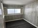 Simple bedroom with wood-paneled walls and neutral carpet at 1713 Chestnut St, Columbus, IN 47201