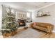 Living room with a fireplace, hardwood floors and a decorated Christmas tree at 2264 Moon Shadow Ln, Indianapolis, IN 46280