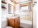 Clean bathroom with a tub, shower, and wood vanity at 3045 31St St, Columbus, IN 47203