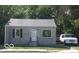 Front view of a ranch house with a tan brick exterior and a white door at 3716 N Emerson Ne Ave, Indianapolis, IN 46218
