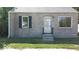 Tan brick ranch home with dark shutters, white door, and small front yard at 3716 N Emerson Ne Ave, Indianapolis, IN 46218