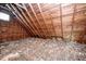 Unfinished attic space with exposed wooden beams and insulation at 4022 N New Jersey St, Indianapolis, IN 46205