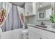 Bathroom with floral shower curtain, granite countertop, and copper sink at 4314 Lantern Rd, Martinsville, IN 46151