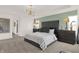 Main bedroom with plush bed, accent wall, and large window at 4342 Chital Pl, Greenwood, IN 46143