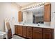 Double vanity bathroom with updated light fixtures and cabinetry at 5414 Honey Manor Dr, Indianapolis, IN 46221