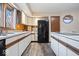 Galley kitchen with white cabinets and black appliances at 5414 Honey Manor Dr, Indianapolis, IN 46221